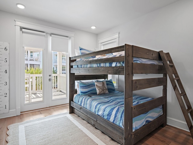 bedroom with dark hardwood / wood-style flooring and access to outside