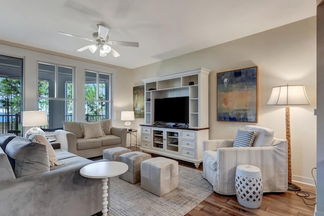 living room with light hardwood / wood-style flooring and ceiling fan