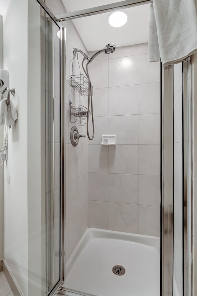 bathroom with a shower with shower door