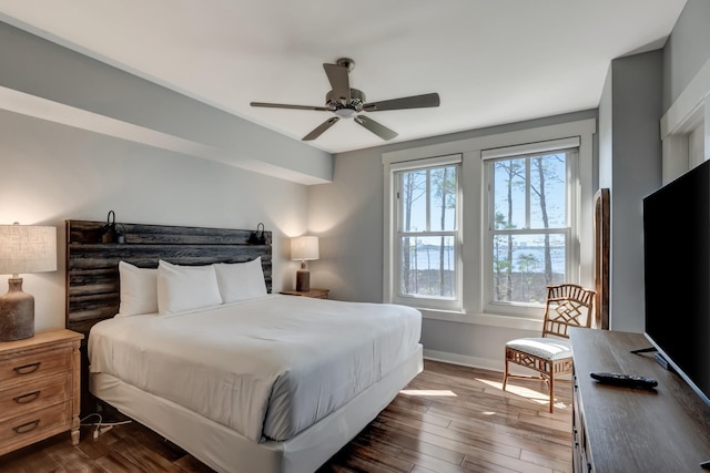 bedroom with ceiling fan and dark hardwood / wood-style flooring