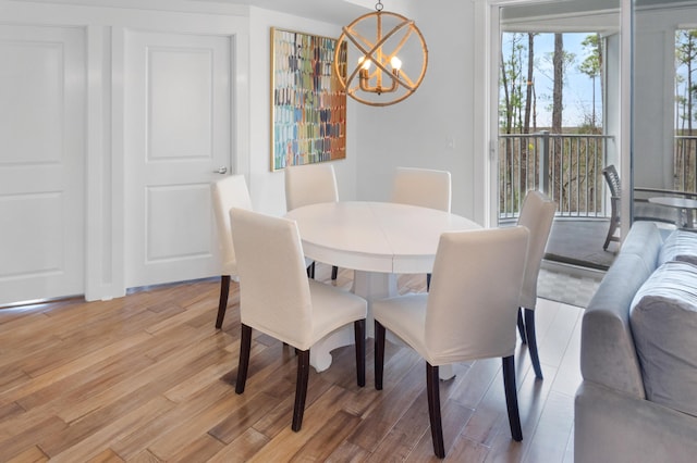 dining space with a chandelier and light wood-type flooring