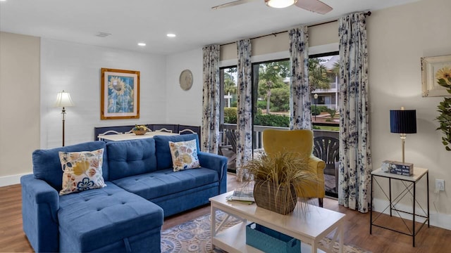 living room with ceiling fan and wood-type flooring