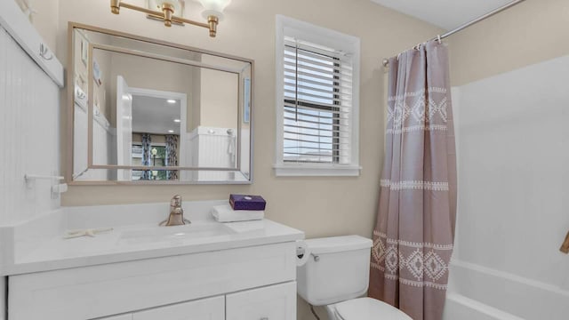 full bathroom with vanity, shower / tub combo, and toilet