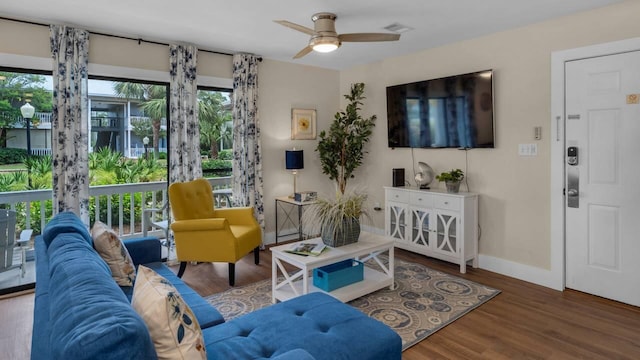 living room with hardwood / wood-style flooring and ceiling fan