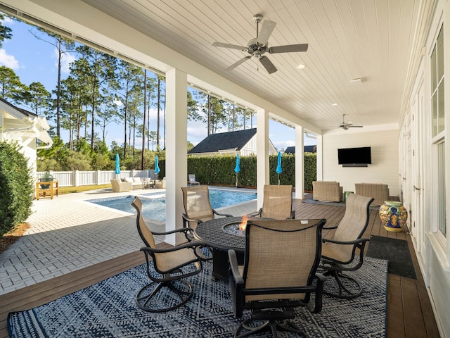 view of patio / terrace with ceiling fan and a fenced in pool