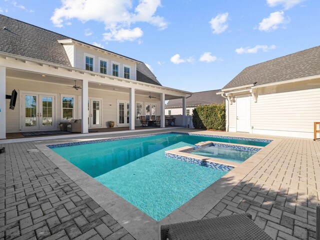 view of pool featuring french doors, ceiling fan, an in ground hot tub, and a patio area