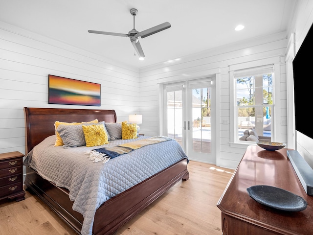 bedroom with ceiling fan, access to exterior, light wood-type flooring, and french doors