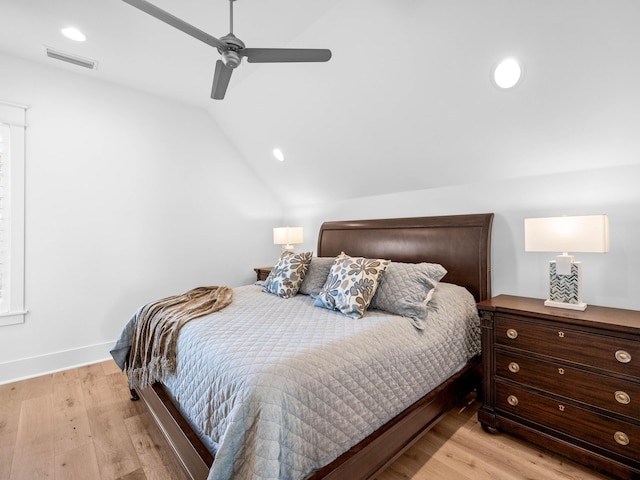 bedroom featuring ceiling fan, lofted ceiling, and light wood-type flooring