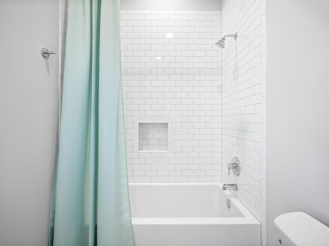 bathroom with shower / bathtub combination with curtain and toilet