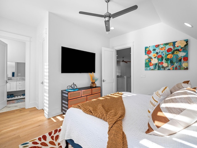 bedroom with vaulted ceiling, ensuite bathroom, hardwood / wood-style flooring, a spacious closet, and ceiling fan