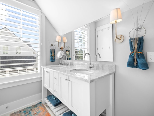 bathroom with lofted ceiling and vanity