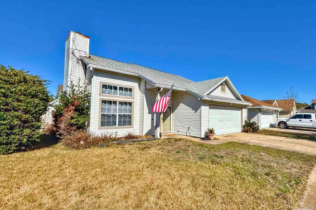 ranch-style house featuring a garage and a front yard