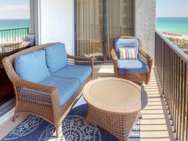 balcony featuring a water view and a view of the beach