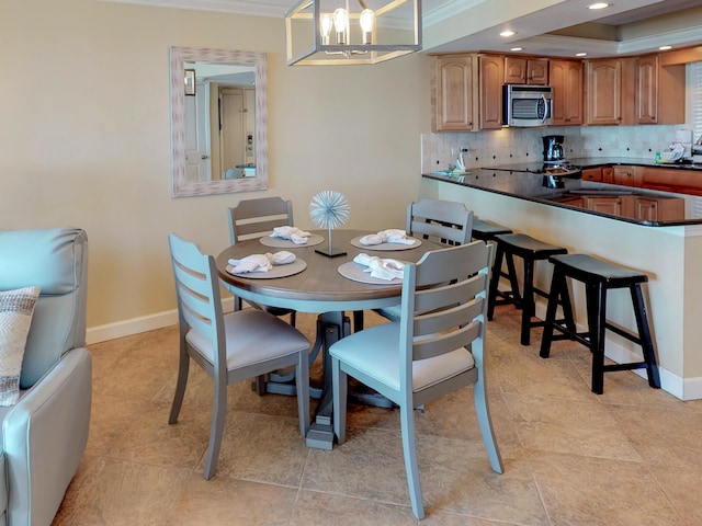 dining space featuring crown molding, a chandelier, and a raised ceiling