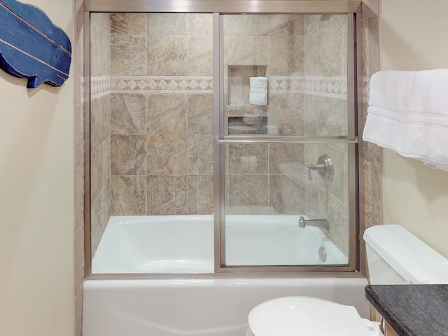 bathroom with enclosed tub / shower combo and toilet