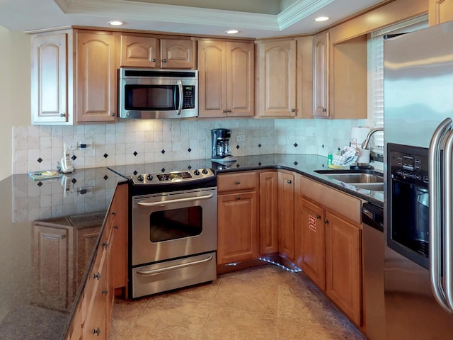 kitchen featuring tasteful backsplash, sink, stainless steel appliances, and dark stone countertops