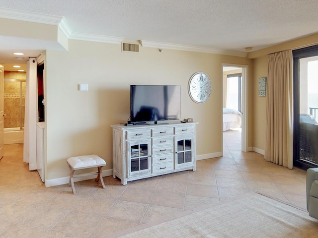 tiled living room featuring ornamental molding and a textured ceiling