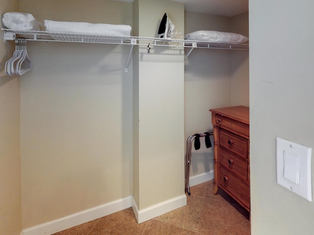 spacious closet featuring light tile patterned floors