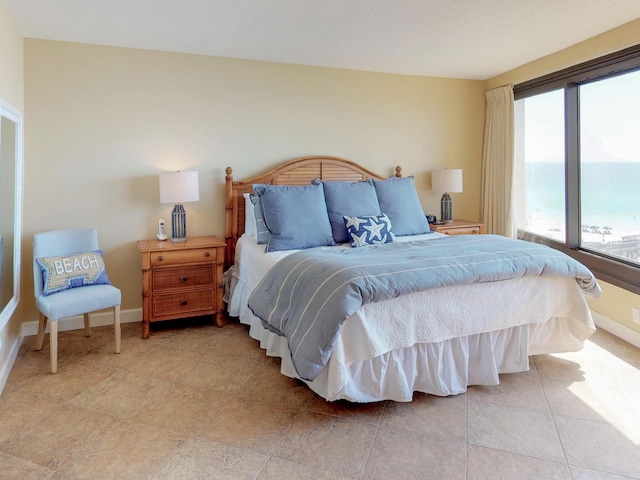 tiled bedroom with a water view