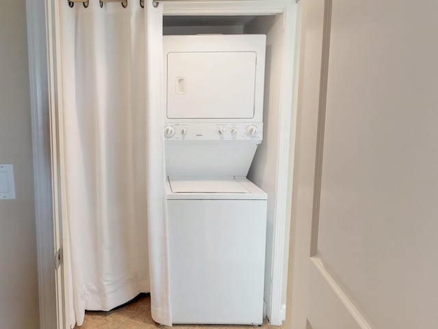 laundry room featuring stacked washer / drying machine