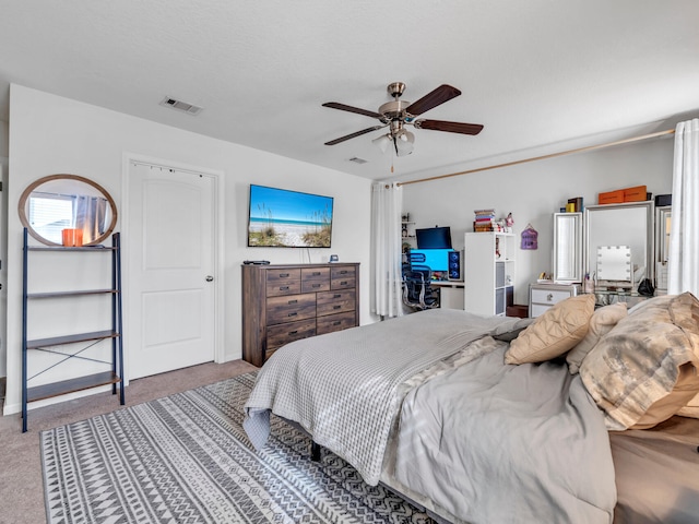 bedroom featuring ceiling fan and carpet