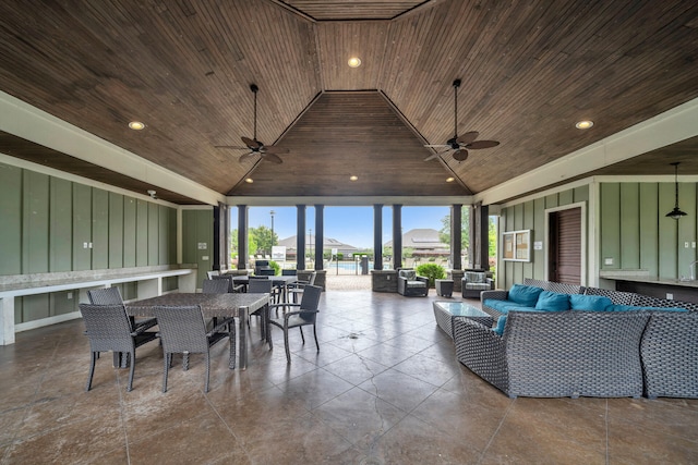 interior space with outdoor lounge area and ceiling fan