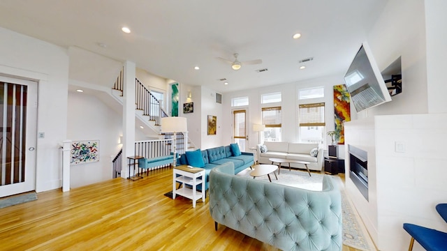 living room with hardwood / wood-style flooring and ceiling fan