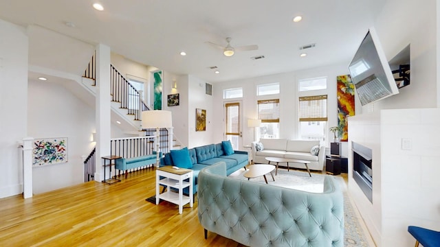 living room featuring ceiling fan and wood-type flooring