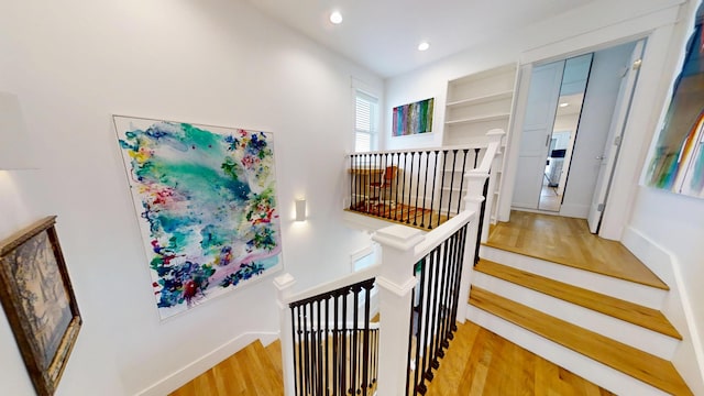 staircase featuring wood-type flooring