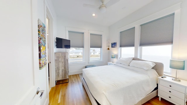 bedroom featuring ceiling fan and light hardwood / wood-style flooring