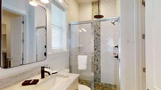 bathroom with walk in shower and vanity