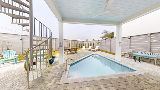 view of pool featuring ceiling fan and a patio