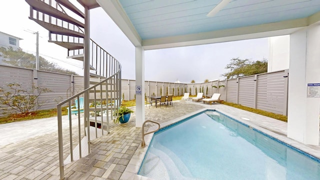 view of swimming pool with a patio area