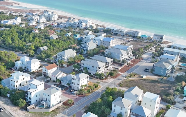 bird's eye view with a water view and a beach view