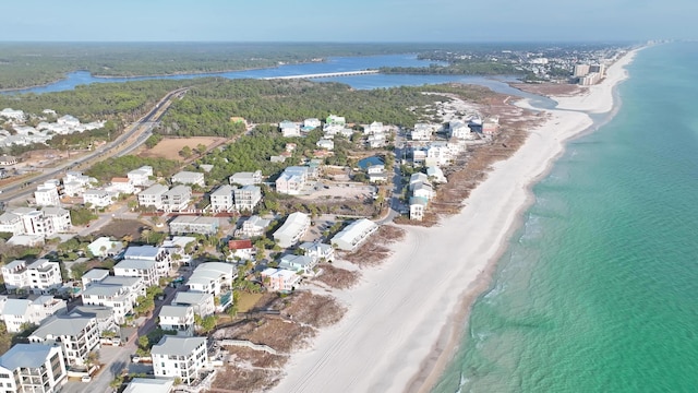 drone / aerial view with a water view and a beach view