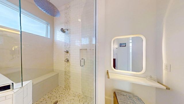 bathroom featuring a shower with door