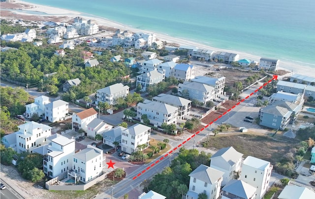 bird's eye view featuring a water view and a beach view