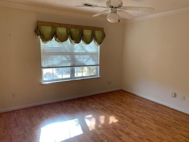 unfurnished room featuring hardwood / wood-style floors, ornamental molding, a textured ceiling, and ceiling fan