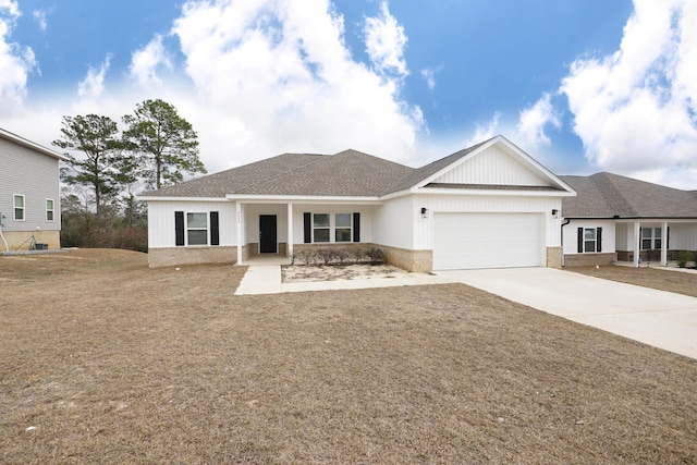 view of front of property featuring a garage and a front lawn