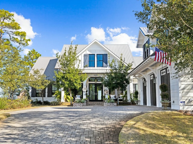 modern farmhouse with a standing seam roof and metal roof