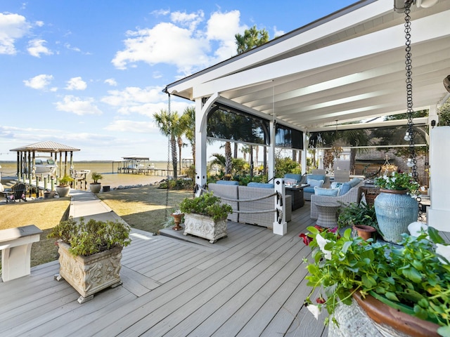 wooden terrace featuring outdoor lounge area and a water view