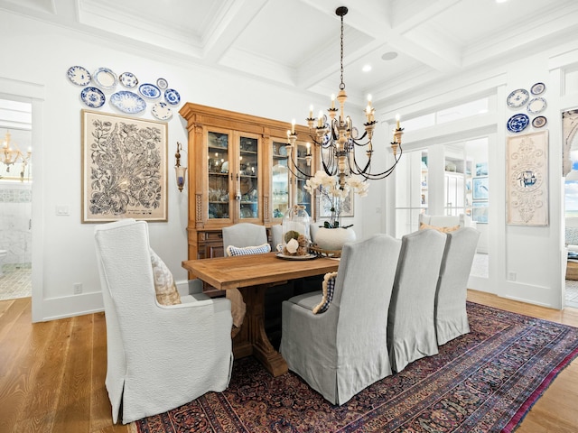 dining room featuring a chandelier, coffered ceiling, wood finished floors, and beam ceiling