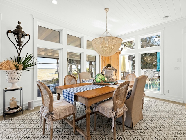 dining space with crown molding and baseboards