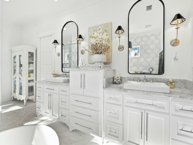 full bathroom featuring double vanity, ornamental molding, a sink, and visible vents