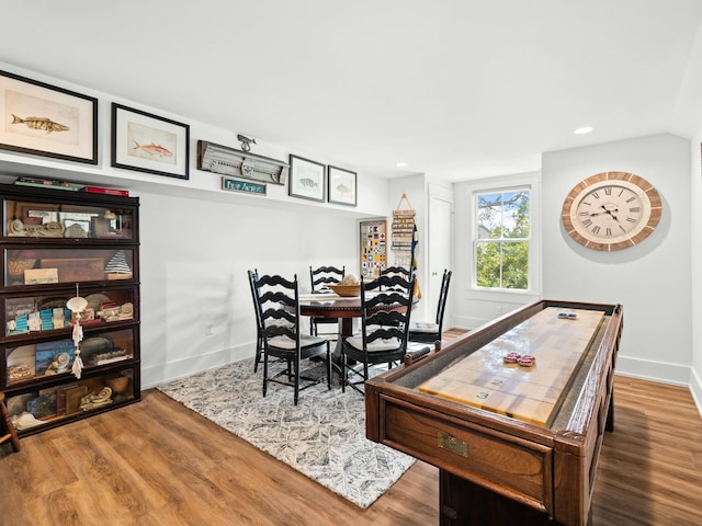 dining room featuring baseboards, wood finished floors, and recessed lighting