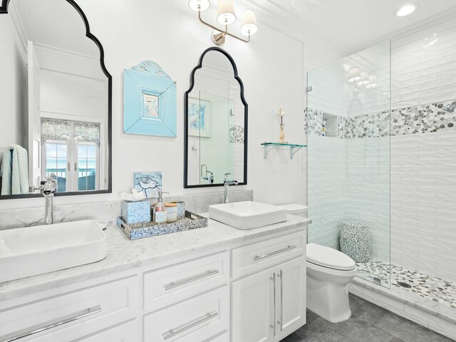 bathroom featuring a sink, a shower stall, and toilet