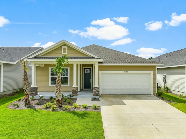 view of front of property with a garage, a porch, and a front lawn