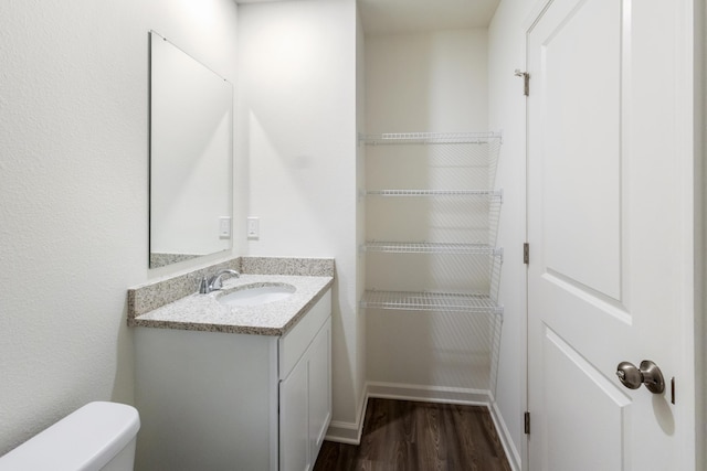 781 Girl Scout Rd, Defuniak Springs, FL 32433 - bathroom with wood finished floors, vanity, toilet, and baseboards
