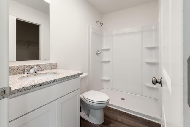 781 Girl Scout Rd, Defuniak Springs, FL 32433 - bathroom featuring wood finished floors, a shower, toilet, and vanity
