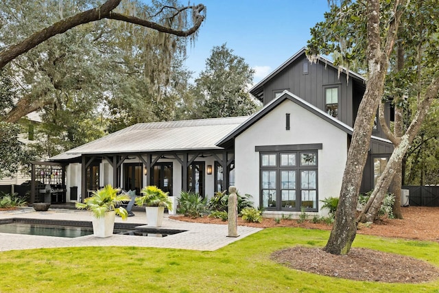 back of house with a yard and a patio area